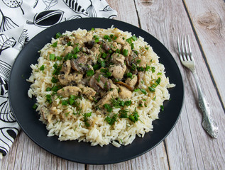Chicken with mushrooms and rice with greens with cream sauce