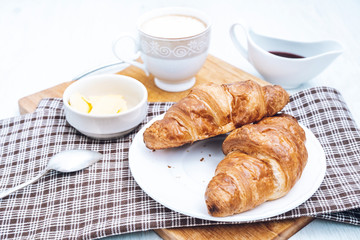 Coffee with croissants for breakfast. Two classic croissants. Tasty french breakfast.