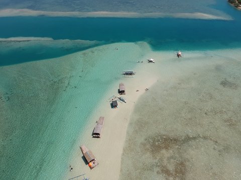 Aerial multiple boats and rafts in a sandbar (Puting Buhangin) in Catalagan, Batangas in Luzon Philippines