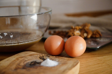 
The ingredients for making muffins lie on a wooden tabletop. photo with place for text