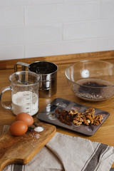 
The ingredients for making muffins lie on a wooden tabletop. photo with place for text