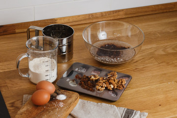 
The ingredients for making muffins lie on a wooden tabletop. photo with place for text
