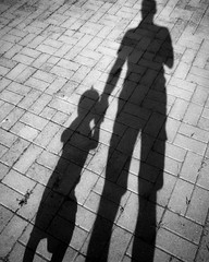 shadows of father and son hand in hand