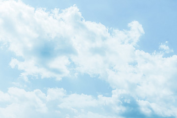 Fluffy white clouds on a clear blue background float in the sky. Spring-summer. Divine view. Concept calm, blue blood, aristocrat.