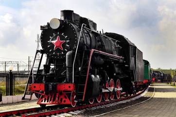 Fototapeta na wymiar Vintage train. First train. The first locomotive. Black locomotive on the rails. Vintage railway. Vintage steam locomotive.