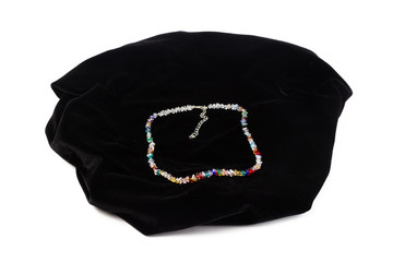 Natural Crystal Beads on Black Velvet. On a white background isolate