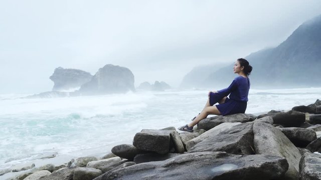 Young woman enjoying a foggy Papuma beach view