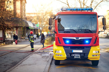 Fototapeta na wymiar Fire truck. First Responders .Fireman in fire fighting operation.