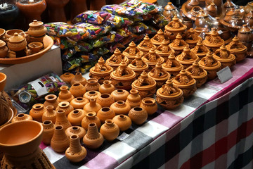 A lot of small handcraft pottery on a table.
