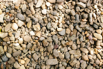 Various pebble stones for background in top view.