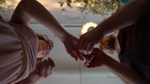 wedding and betrothal look and angle from below. Husband and wife change wedding rings. Bride and groom kiss and hug. Beautiful angle and good mood