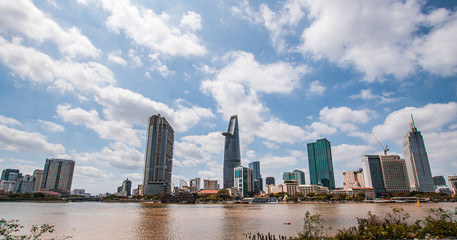 Fototapeta na wymiar Saigon skyline and the Saigon River with Bitexco tower. Ho Chi Minh City is a popular tourist destination of Vietnam.