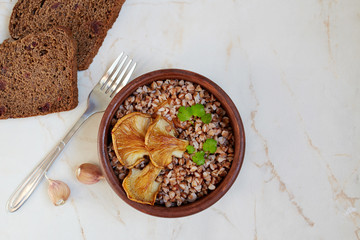 Buckwheat porridge with oyster mushrooms on a light background