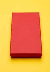Fototapeta premium Red box product packaging isolated on yellow background.