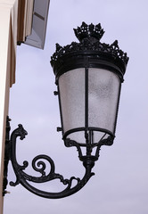 Fototapeta na wymiar Forged, iron lantern at the entrance to the royal palace