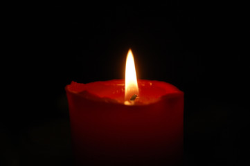 Red candle on a black background