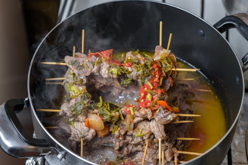 Armenian cuisine. In a frying pan with roast beef. In a pan