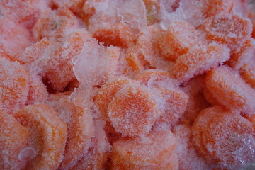 Closeup of frozen carrots slices with ice frosting