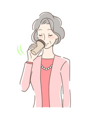 テイクアウトのコーヒーを飲む女性