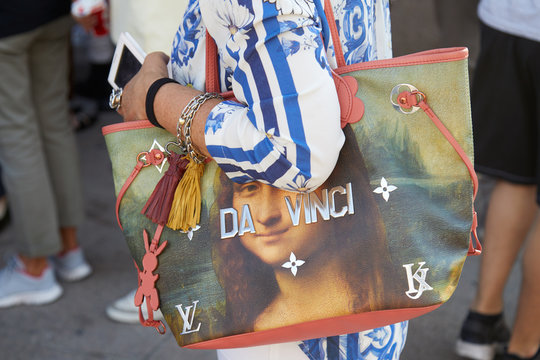 Woman with Da Vinci Louis Vuitton bag with Mona Lisa on June 15, 2018 in Milan, Italy