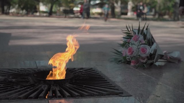 Eternal flame burns near the monument in slow motion
