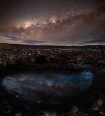 Die Milchstraße über einer gefrorenen Wasserpfütze im Hochland von Bolivien.