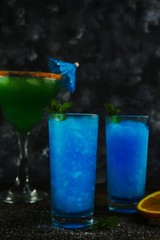 Frozen Blue Lagoon Cocktail against black background, selective focus