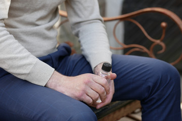 Person is using hand sanitizer to wash hands while outdoor. High hygiene. Corona concept. Spring and summer during global pandemic crisis. COVID-19 virus. Coronavirus.Handshaking.