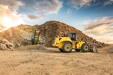 Excavator and stone crusher in a quarry