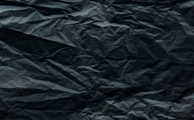 crumpled dark gray wrapping paper slightly blurred