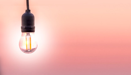 Several LED bulb on pink sunset background. Saving energy concept