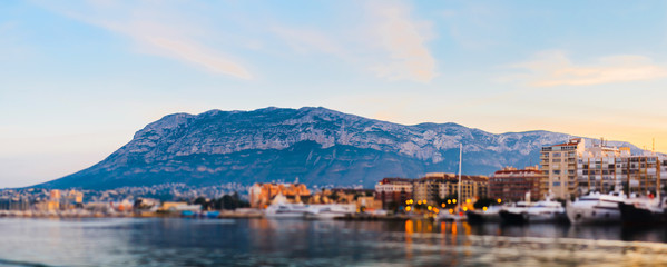 Beautiful sunset view of Mount Mongo and the port of Denia Spain. Tilt Shift focus focus on buildings