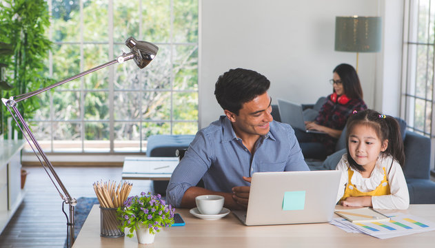 Family Staying And Working In Living Room