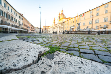 Piazza Navona in Rome appears like a ghost city during the covid emergency  lock down, grass on the...
