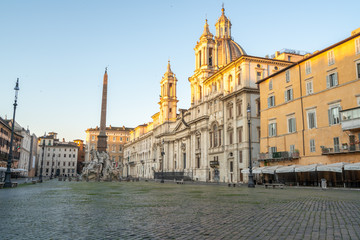 Fototapeta na wymiar Piazza Navona in Rome appears like a ghost city during the covid emergency lock down, grass on the floor