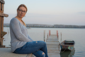 Fototapeta na wymiar A woman by the Marina on the Danube in Dubovac.