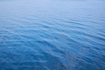 Naklejka premium Background from the blue surface of the water of the sea, ocean. Smooth the water.