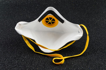 Protective mask on black background, with filter - virus covid19 - coronavirus