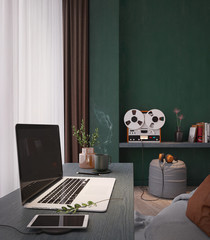 Workspace with laptop.Smart phone charging,vase,coffee cup on wooden desk.White and brown curtain with vintage style decorative on green wall.Work from home concept.3d rendering