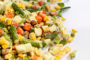 Frozen vegetables. Frozen vegetable mixture of carrots, corn and peas, celery and corn. Mexican mix. On white background.