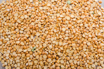 yellow peas for background. The texture of pea groats.