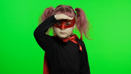 Funny child girl in costume and mask plays super hero. National superhero day