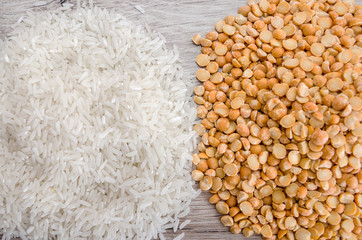 rice and yellow peas on a wooden background. View from above. Close-up.