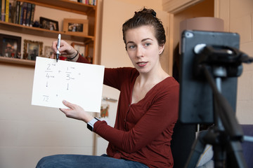School teachers are forced to teach their lessons from home using their phones to video themselves