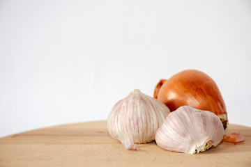 Onion and garlic on wooden table