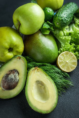 green vegetables and fruits on black background