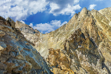 Picturesque mountain scenery with cumulus clouds. Wildlife. Hiking. Daytime. journey