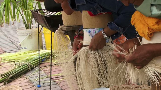 People weaving panama hats close up 