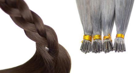 Set of tow different colors hair extensions , isolated on white background. Brown and silver hair...