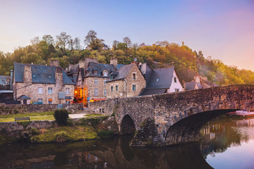 The picturesque medieval port of Dinan on the Rance Estuary, Brittany,France.The medieval city of Dinan in the setting sun, a popular tourist spot in France - obrazy, fototapety, plakaty